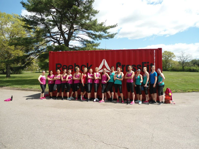 Group photo of Fitfluential bloggers posing in front of a big red shipping container outside of the Reebok CrossFit One facility