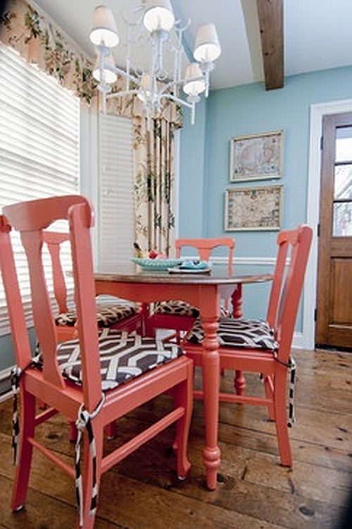 pretty coral chairs in a blue dining room
