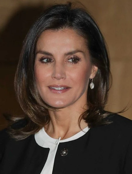 Queen Letizia wore Hugo Boss silk blouse, Caolina Herrera jacket and, Mango Prince of Wales trousers and pearl earrings