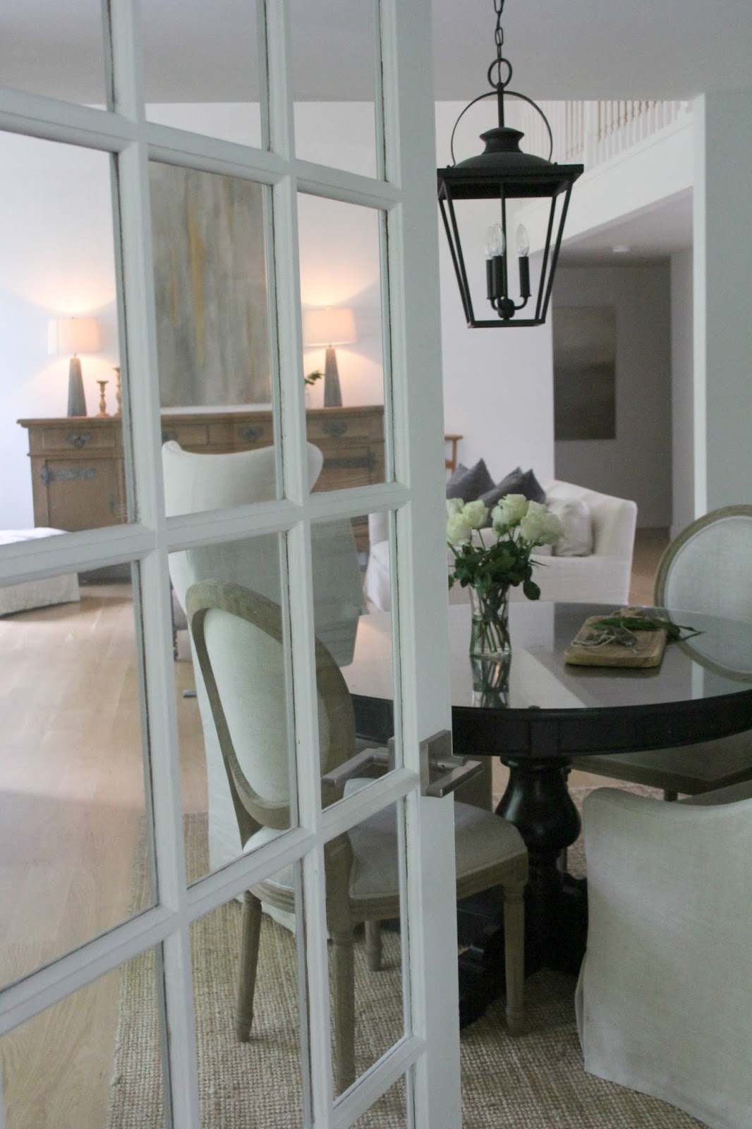 Hello Lovely's vintage French doors to dining room and living room with European country casual style.