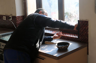 Bekir grouts the splashback in the kitchen Bekir grouts the splashback in the kitchen