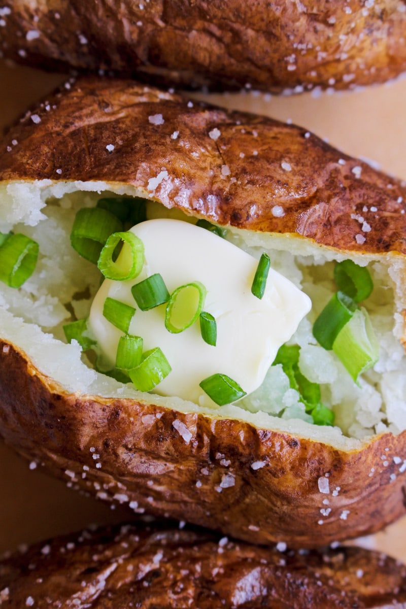 Air Fryer Salty Skin Baked Potatoes | The Two Bite Club | #airfryer #bakedpotato #sidedish These baked potatoes cooked in the air fryer have a perfectly cooked fluffy inside and an irresistible crispy salty skin. You can eat them as a side dish or enjoy them as a light main dish! #airfryer #bakedpotato #sidedish