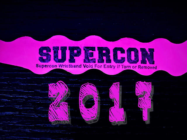 Supercon writstband on a black background and the year, 2017, below.