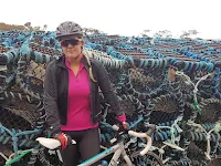 woman in front of lobster pots