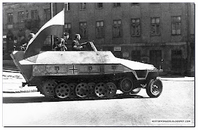 Armia Krajowa fighters ride  captured German armored carrier streets  Warsaw August 1944 uprising
