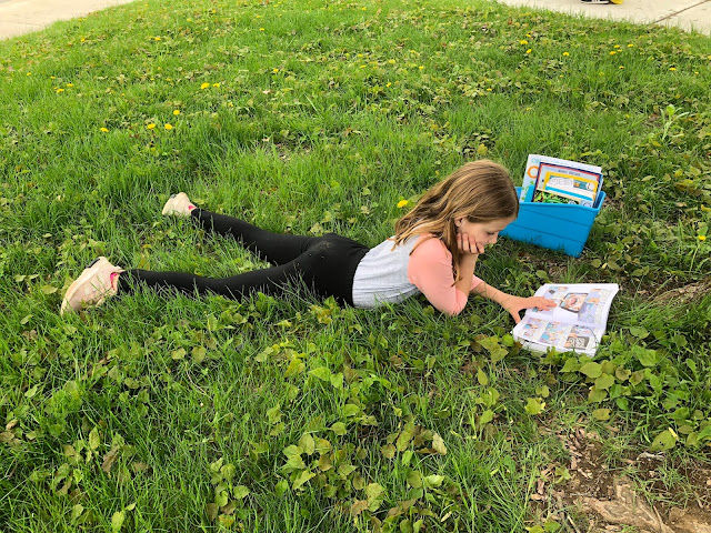 student reading in grass