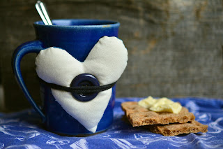 mug with fabric heart tied to it, cookies on the side