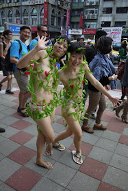 same two young women who are dressed with minimal covering and vines at 2011 Taiwan LGBT Pride Parade