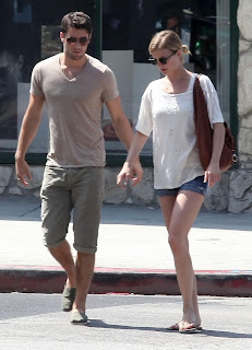 Emily VanCamp and Josh Bowman holding hands
