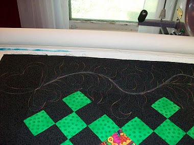Mystery Quilt border with freeform whimsical feathers