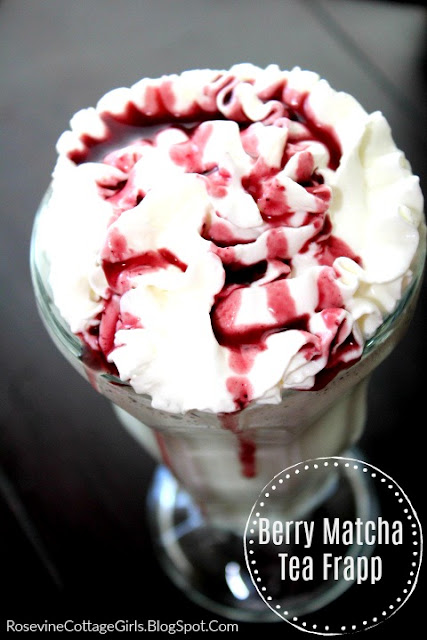 A clear glass filled with green tea frappuccino topped with delicious fluffy whipped cream and drizzled with a dark red berry syrup over the top #Frapp #Drinks #SummerRecipes #MatchaGreenTea #BerryMatchaTeaFrapp