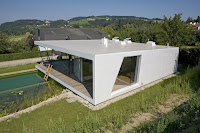 modelo de casa moderna blanca con grandes ventanales un piso vista trasera