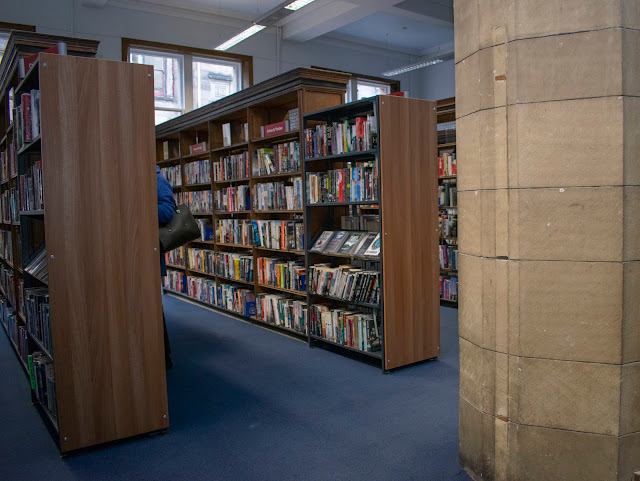 Brown shelves of books in library