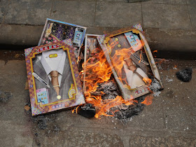 boxes with paper shirts, ties, and suits jacket burn
