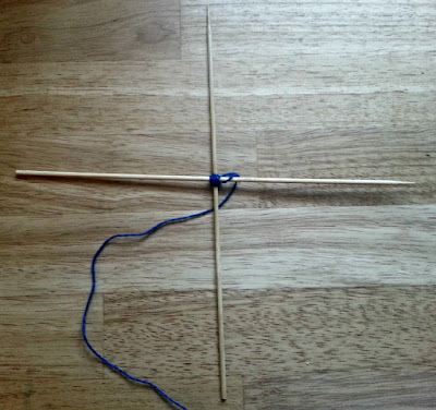 Winding wool around skewers to make a God's Eye Decoration