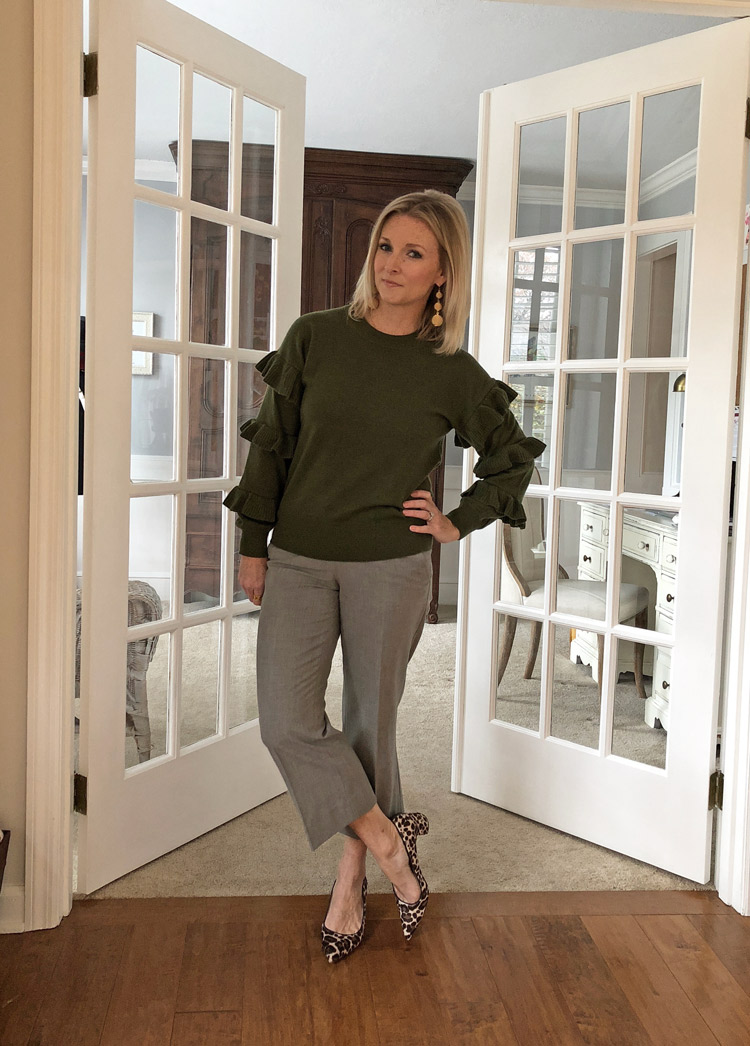 olive ruffle sweater with gray pants and leopard heels