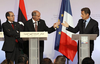 France's President Nicolas Sarkozy (R), Mustafa Abdel Jalil (C), chairman of the Libyan National Transitional Council (NTC), and Mahmoud Jibril (L), the head of NATO's rpuppet National Transitional Council, hold a joint news conference at the "Friends of Libya" conference at the Elysee Palace in Paris, Sept 1, 2011. [Agencies] 