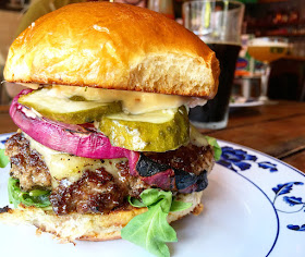 The OG Burger with house-made pickles, grilled red onion and arugula.