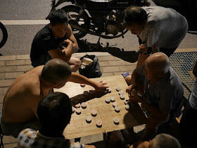 men playing xiangqi at night in Ganzhou, Jiangxi