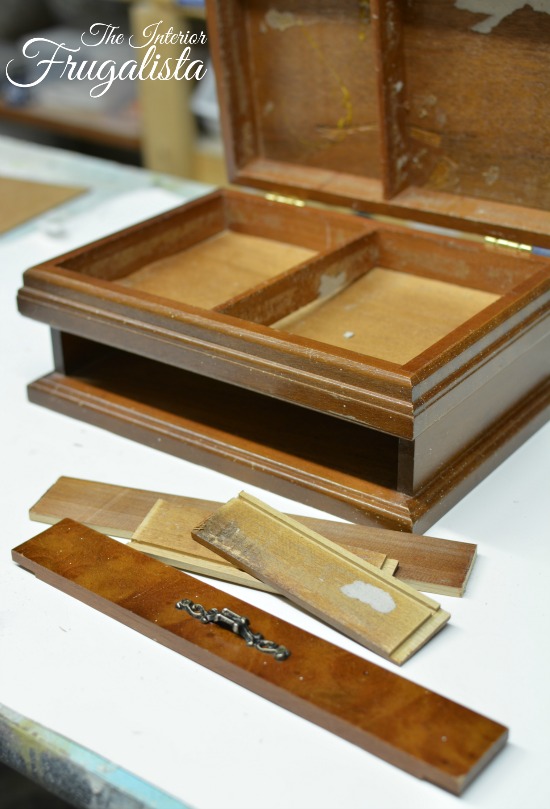 Gutting the interior of a wooden jewelry box to repurpose into handy remote control storage.