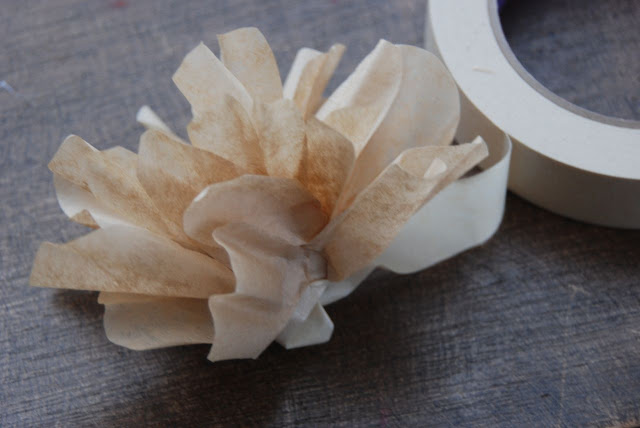 Finish your flower Finish your flower and secure the end of the masking tape.