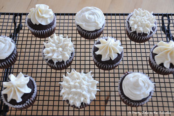 a top down view of a cooling rack filed with Chocolate Beet Cupcakes decorated with vanilla frosting