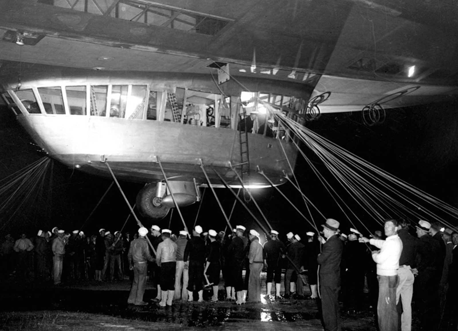 Spectators and ground crew surround the gondola of the Hindenburg as the lighter-than-air ship prepares to depart the U.S. Naval Station at Lakehurst, New Jersey, on May 11, 1936, on a return trip to Germany.