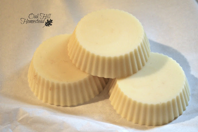 Three hard lotion bars on a white background.