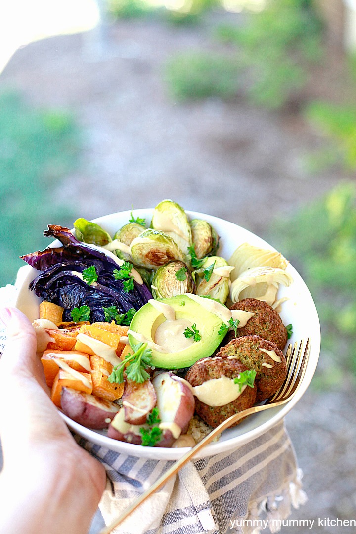 Falafel Buddha bowl Falafel as part of a Buddha bowl filled with quinoa, vegetables, avocado, and tahini sauce.