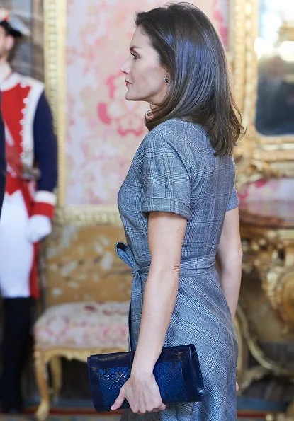 Queen Letizia wore Massimo Dutti wool check dress with belt. She wore Magrit pumps and carried Magrit clutch. Princess Leonor