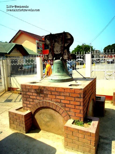 Bell on display in front of San Isidro Labrador Parish Church in Nueva Ecija