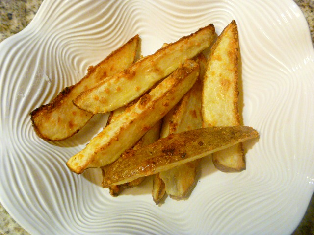 Crispy on the outside and tender on the inside with garlc and melted Parmesan all over the top!  HEAVEN  Savory Garlic Parmesan Potato Wedges - Slice of Southern