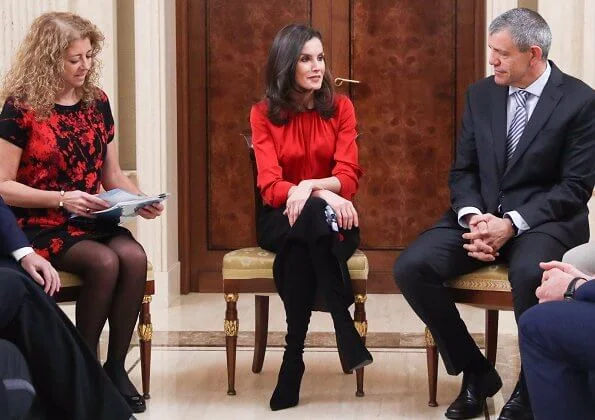 Queen Letizia wore Hugo Boss Banora red gathered neck silk blouse and Carolina Herrera black poppy-print knit skirt, gold diamond earrings