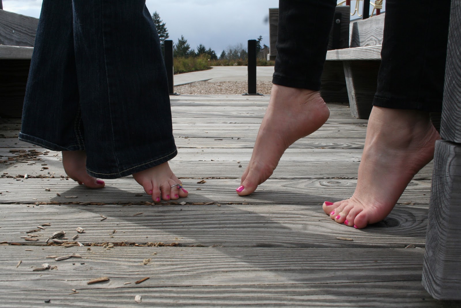 2 Girls Show Off Their Bare Feet Together.