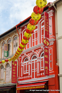 Colourful travel agent in Chinese shophouse in Temple street, Singapore