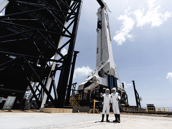 At Kennedy Space Center's Launch Complex 39A, NASA astronauts Douglas Hurley and Robert Behnken pose with the Falcon 9 rocket that sent them on their way to the International Space Station...on May 30, 2020. At Kennedy Space Center's Launch Complex 39A, NASA astronauts Douglas Hurley and Robert Behnken pose with the Falcon 9 rocket that sent them on their way to the International Space Station...on May 30, 2020.