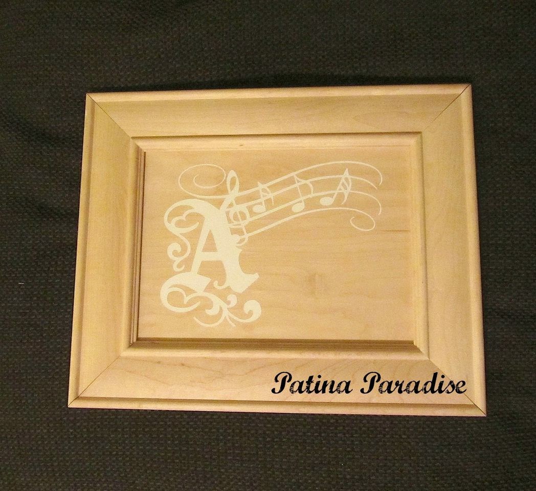 The Embellishment is painted onto the cabinet using the vinyl as a stencil