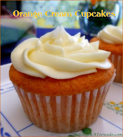 Orange Cream Cupcakes are light and fluffy orange and French vanilla cream flavored cakes frosted with a creamy orange frosting. | Recipe developed by www.BakingInATornado.com | #recipe #dessert