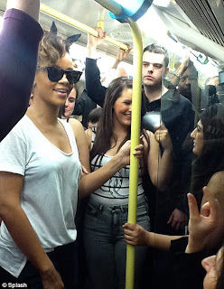 Pictures Of Rihanna riding the London tube with her fans: Damn she couldnt even get a seat. 1