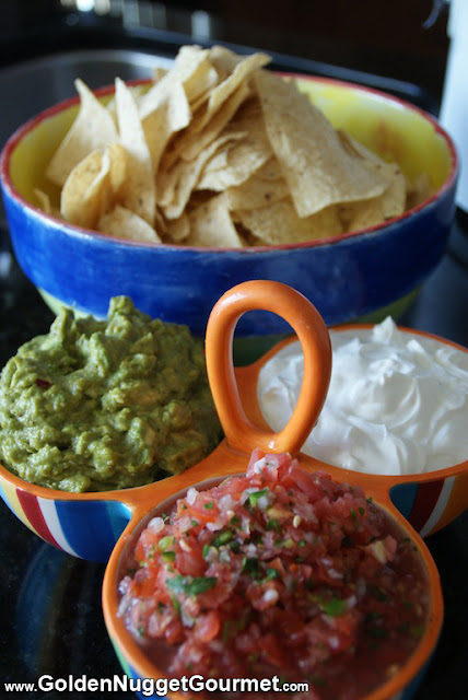 guacamole salsa sour cream in divided serving bowl