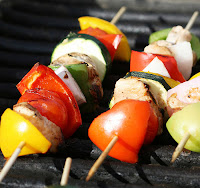 Grilling shishkabobs with chicken and vegetables