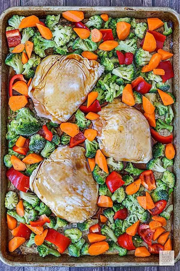 Chicken thighs and vegetables on sheet pan ready to bake for Baked Teriyaki Chicken Thighs