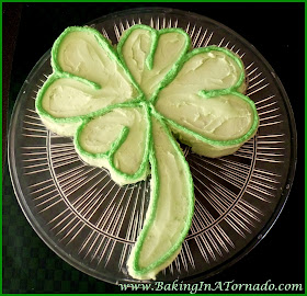 Creme de Menthe Shamrock Cake, a mint flavored, four leaf clover shaped St. Patrick's Day lucky cake.| Recipe developed by www.BakingInATornado.com | #recipe #cookies #StPatricksDay