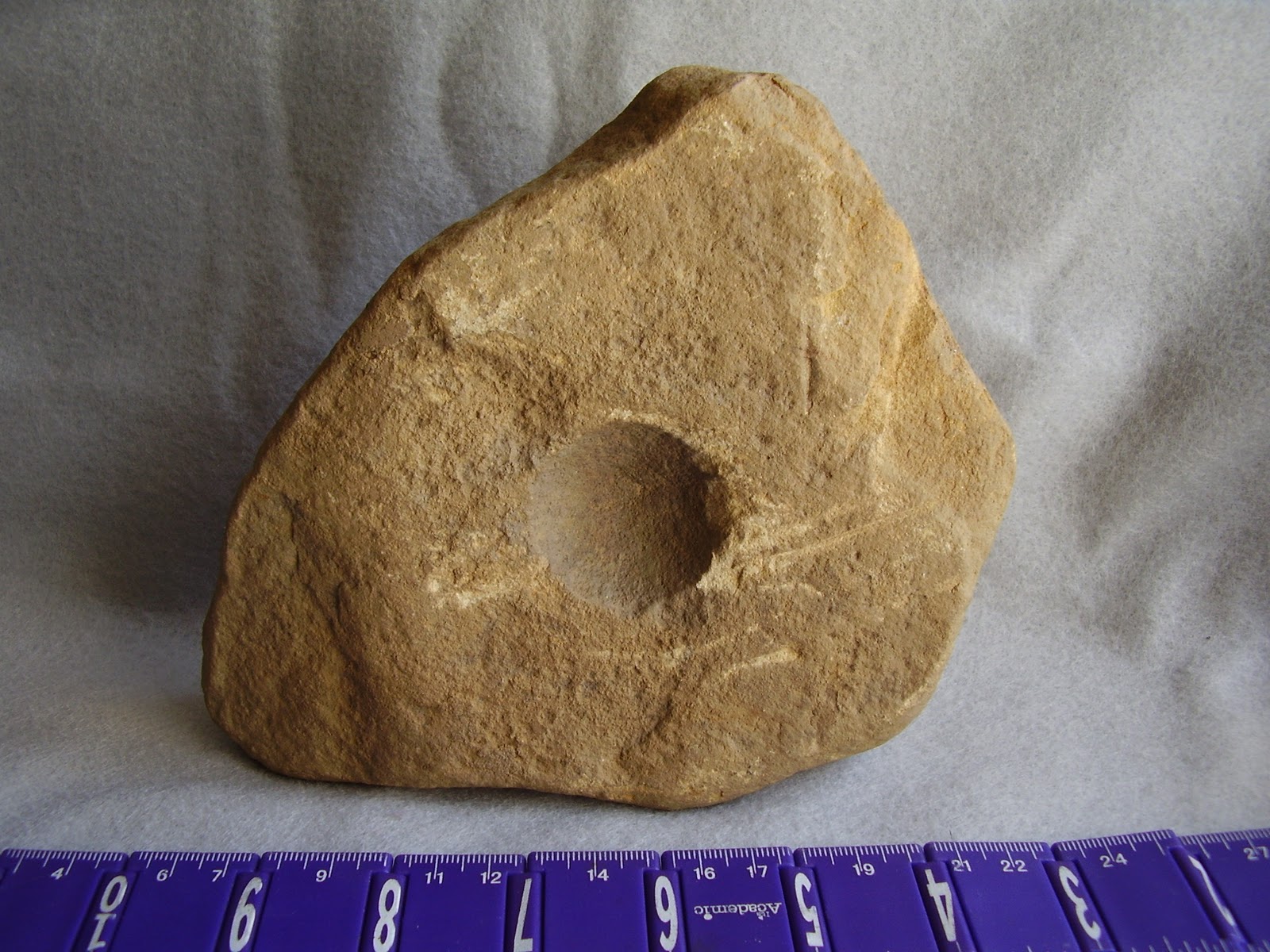 Archaeology of Portable Rock Art Rocks' pits may be art "cupules" on