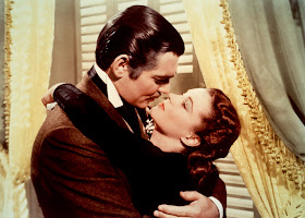 Clark Gable as Rhett Butler embracing Vivien Leigh as Scarlet O'Hara in Gone with the Wind movieloversreviews.filminspector.com