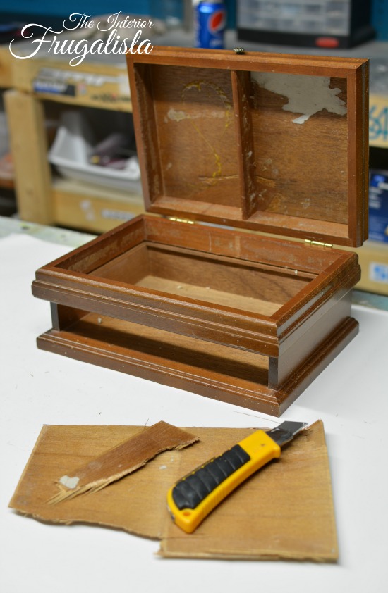 Gutted wooden jewelry box upcycled to store remote controls.