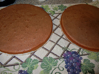 2 round chocolate cakes on a table cloth 