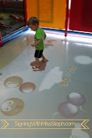 3 year old boy plays a game using an eye-click floor