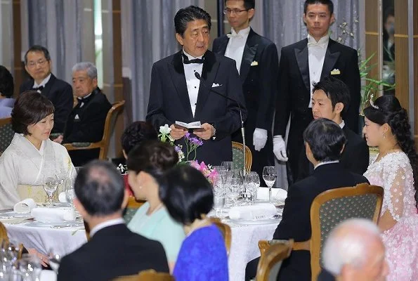 Crown Prince Naruhito and Crown Princess Masako at weeding banquet. Princess Ayako wore a pink silk dress designed by designer Norio Suzuki