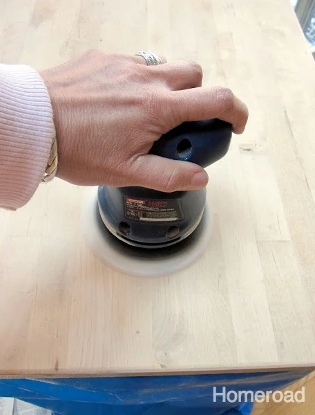 Using a palm sander on the top